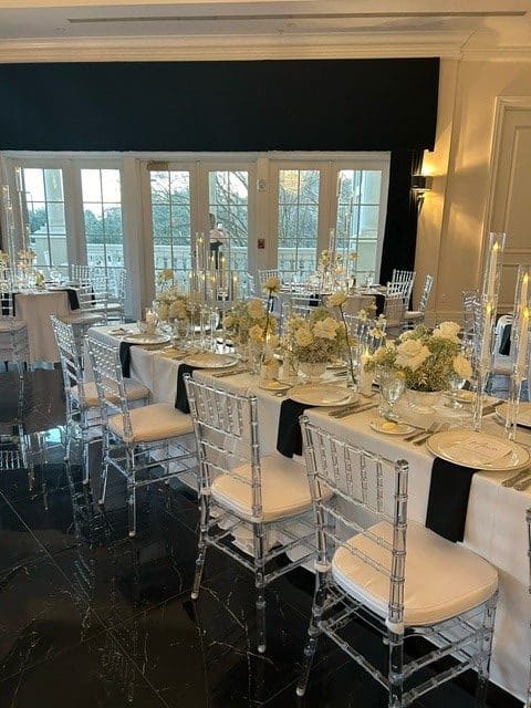 wedding reception set up, long table, white tablecloth, blue napkins, silver backed chairs, white cushions, white floral centerpieces, Orlando, FL
