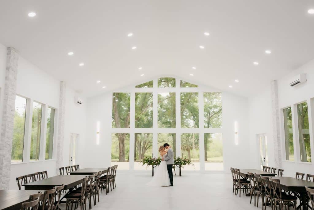 The Whitewood Ranch, indoor wedding venue, white walls and large windows on all sides, tables for the reception, Orlando, FL