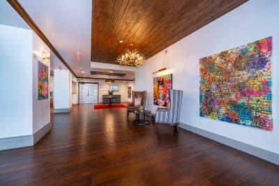 art gallery space, paintings on the walls, wood floors, soft lighting, Eola View, Orlando, FL