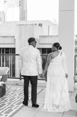black and white photo, bride and groom with their backs to the camera, looking at each other, on then outdoor patio and balcony, Eola View, Orlando, FL