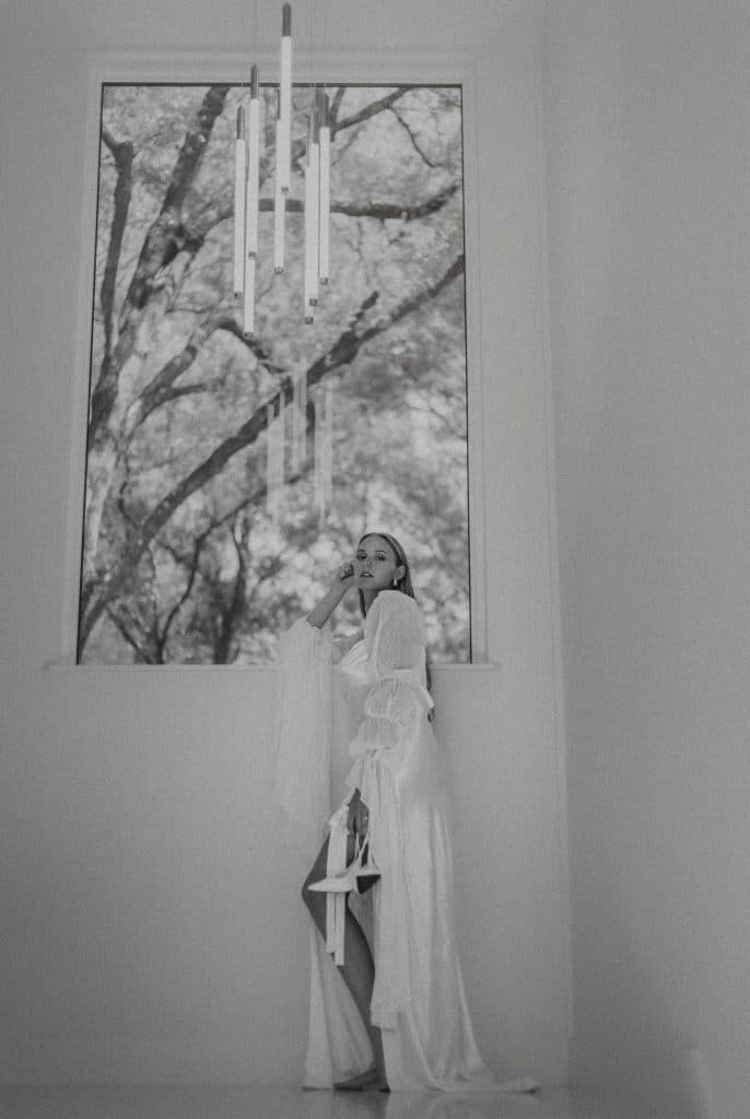 black and white photo of a bride, standing under a window, Orlando, FL