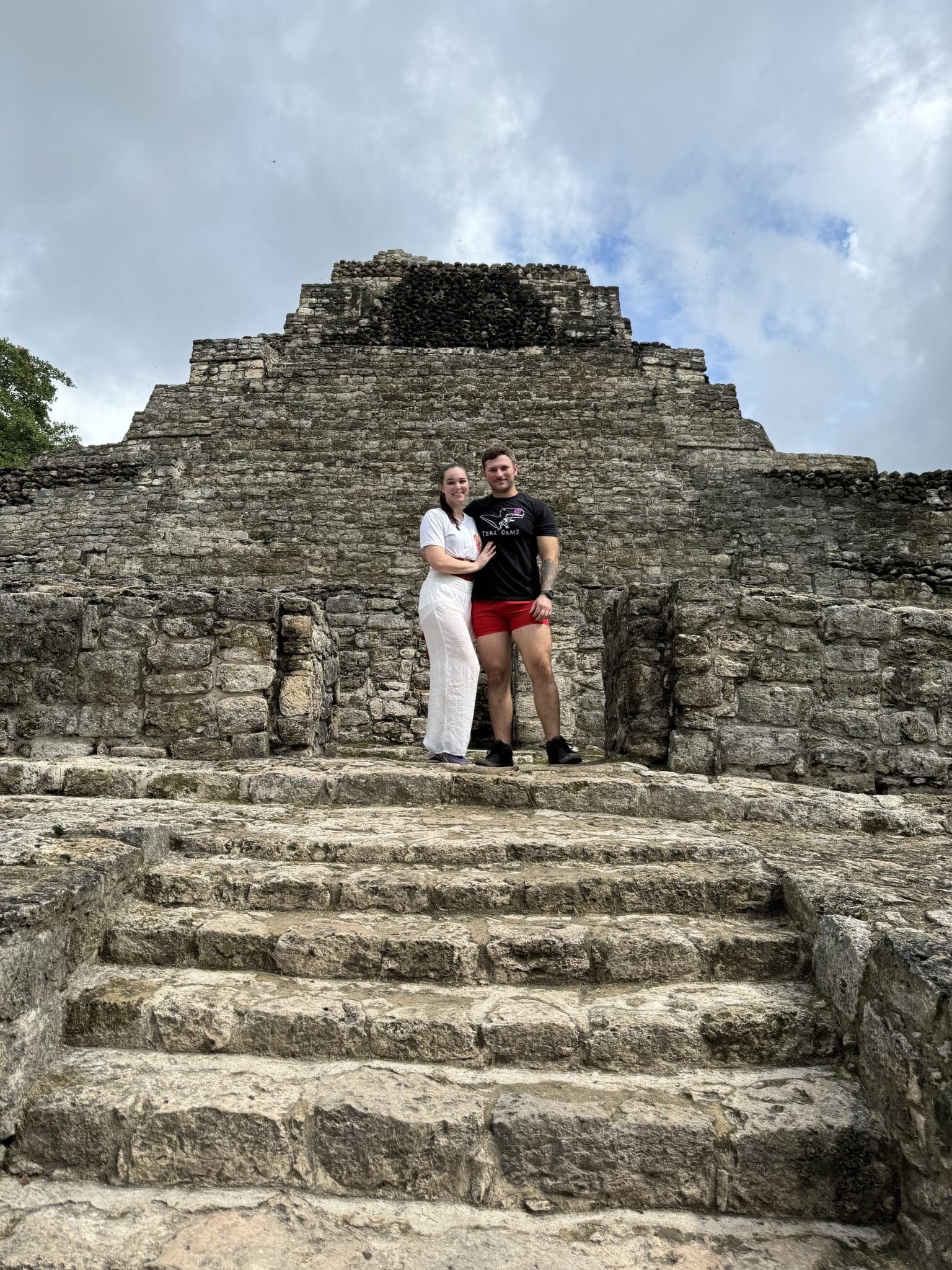 man and woman pose in picture before mayan ruins marriage proposal