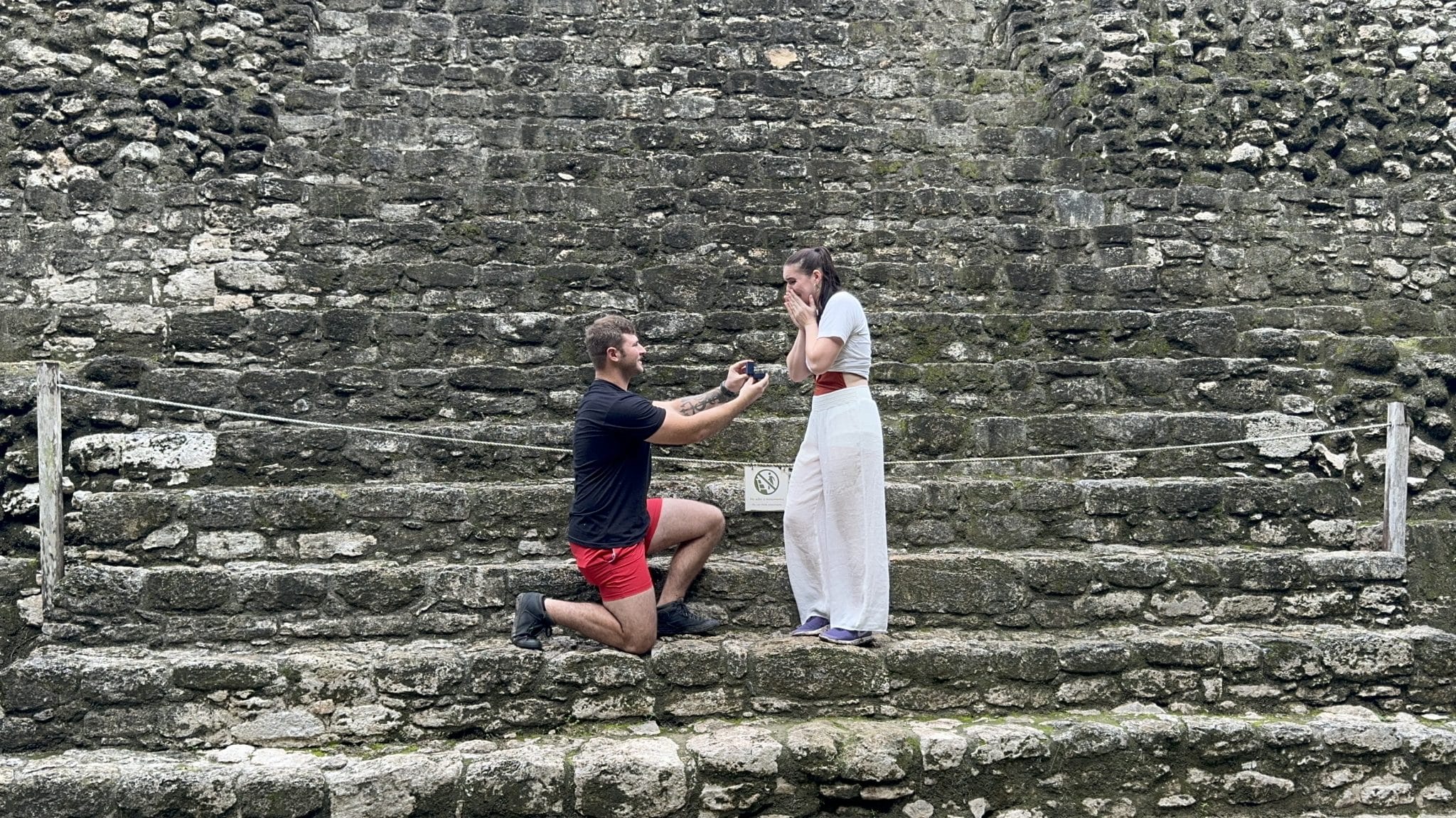 man on one knee at mayan ruins marriage proposal in mexico