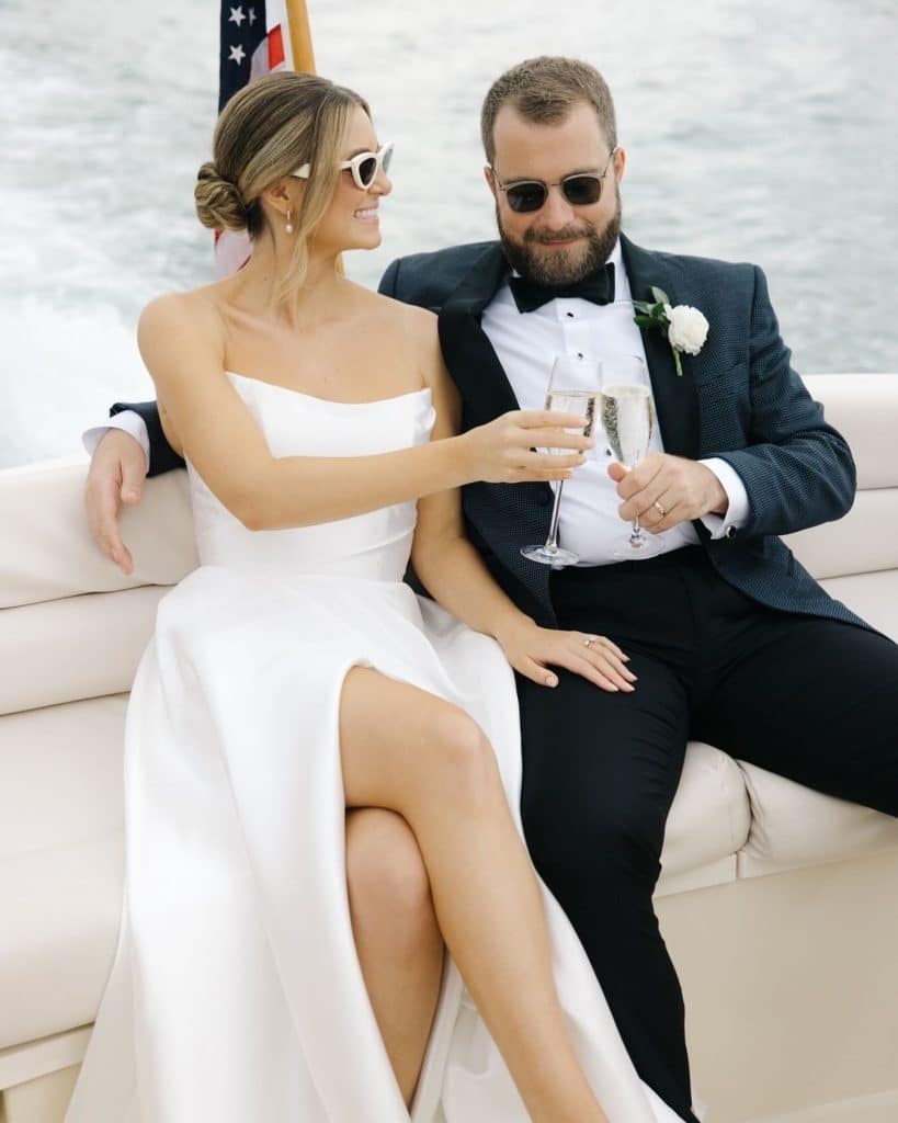 bride and groom relaxing outside on a boat, in the water, celebrating with some champagne, Orlando, FL