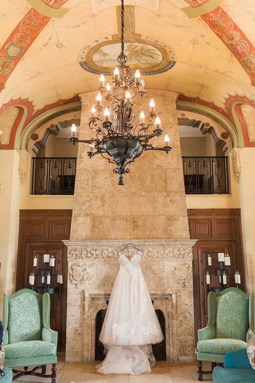 bridal gown hanging above a fireplace, inside the bridal suite at the church, Naomi Zora Events, Orlando, FL