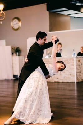 bride and groom dancing, bar area behind, wood floors, Orlando, FL