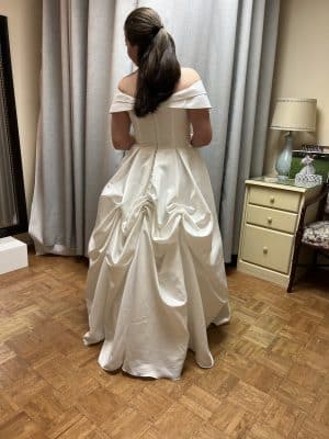 woman looking in the mirror wearing her wedding dress, Sewing by Marilyn, Orlando, FL