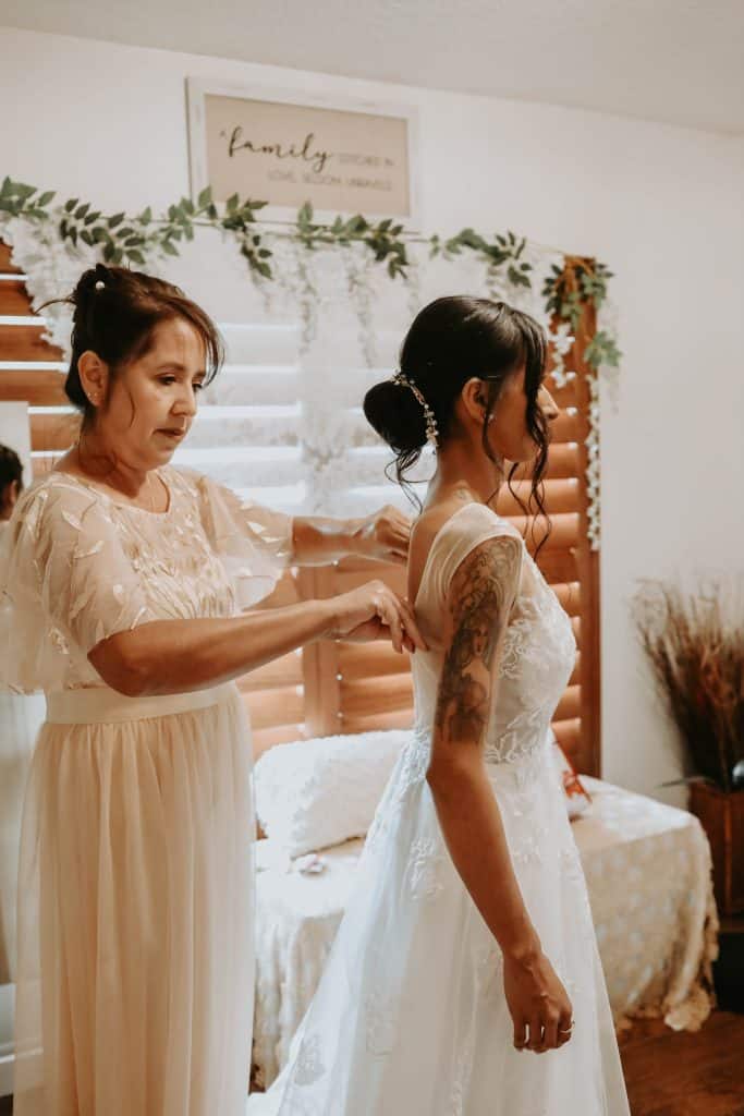 bride having her mother help her finish getting ready for her wedding, Orlando, FL