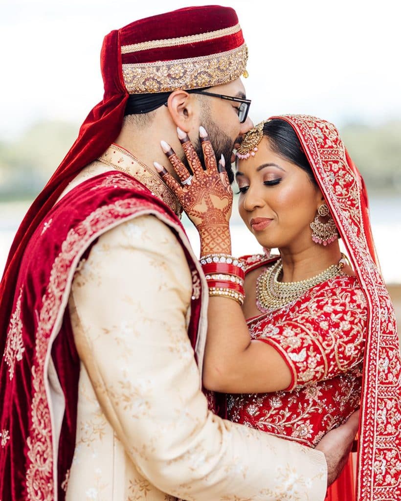 Couple wearing traditional Indian attire, embracing each other, henna, Lillie Shawn Imagery, Orlando, FL