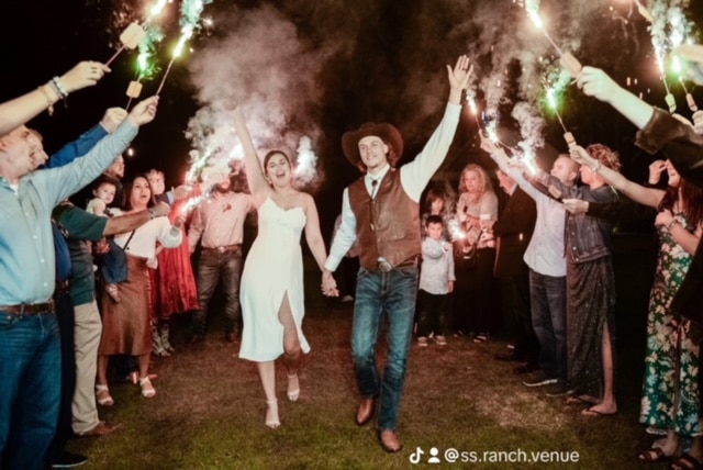 bride and groom walking through the crowd of guests at their reception, sparklers, Orlando, FL