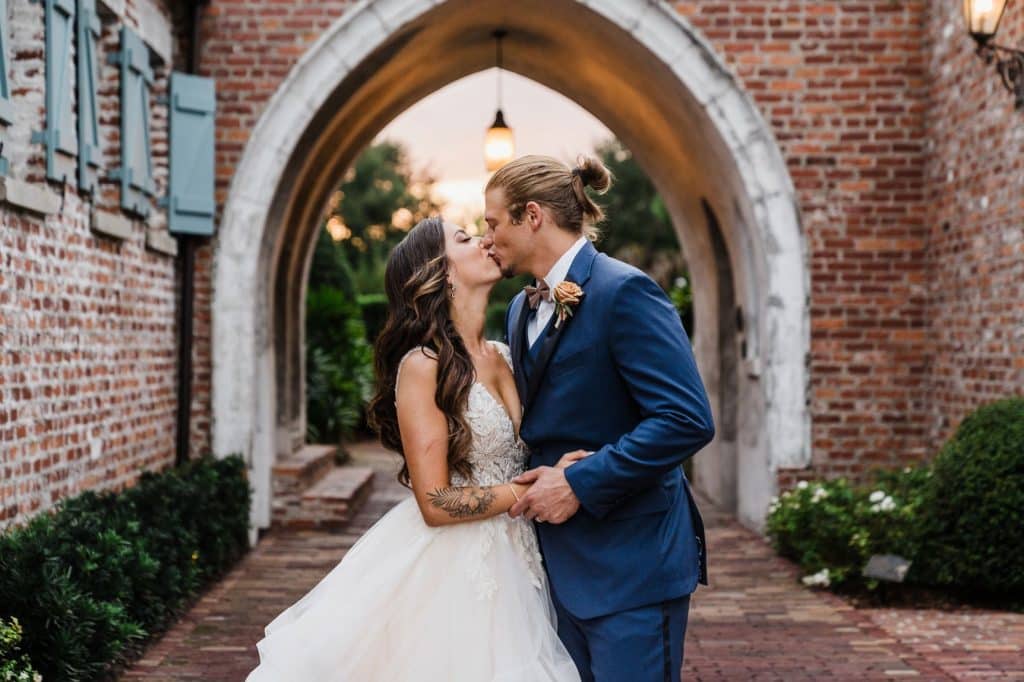 bride and groom kissing under the brick arch, Author Made Photo and Video, Orlando, FL