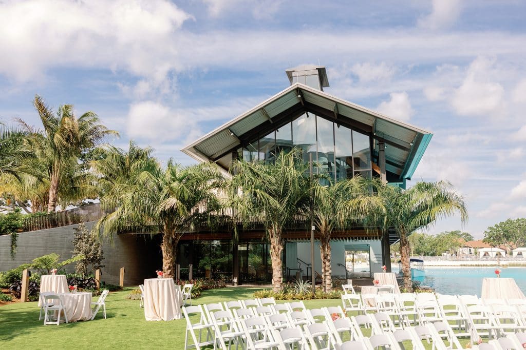 Evermore Orlando Resort, outdoor ceremony set up on lawn, water in the background. blue skies, Orlando, FL