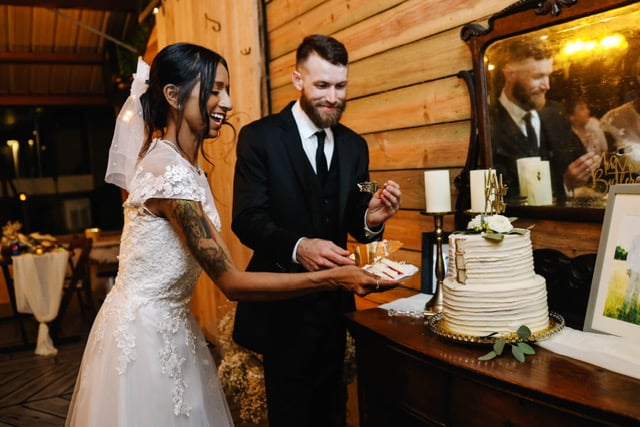 bride and groom cutting their 2 tiered wedding cake, set up on a table, bi-racial couple, Orlando, FL