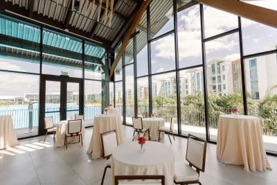 Cocktail reception setup indoors, high tops, large windows, angled ceilings, Orlando, FL