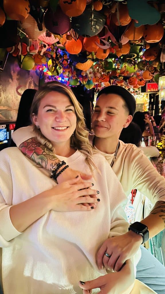 couple pose together in white shirts for picture