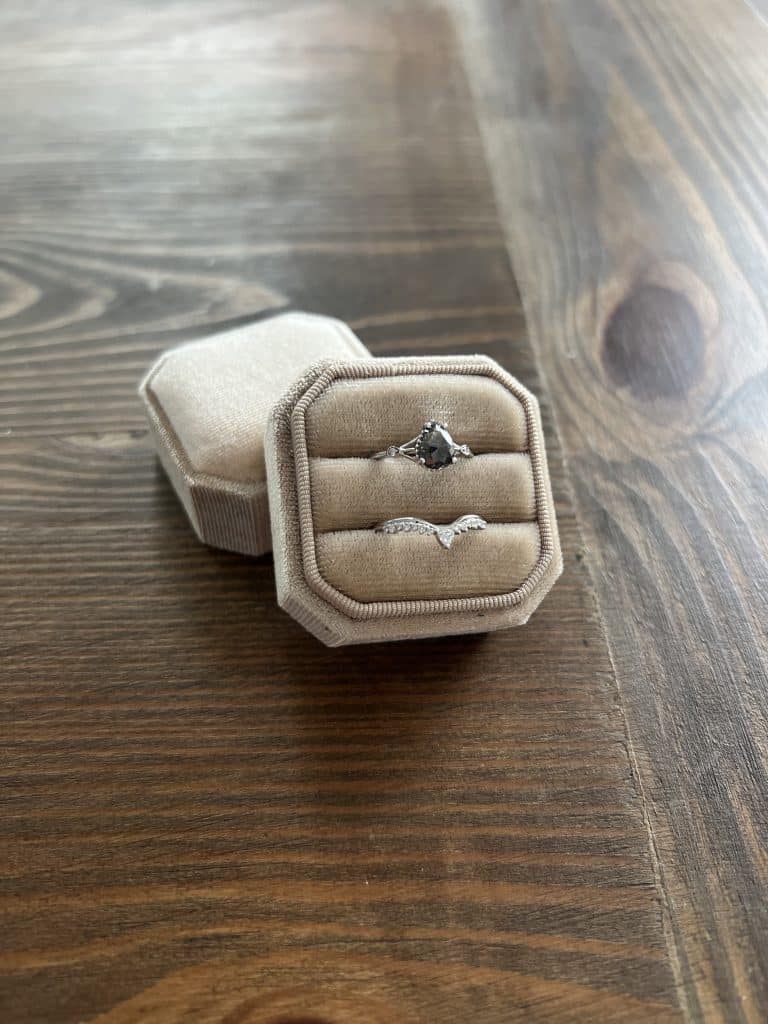 rings in taupe velvet ring box on table