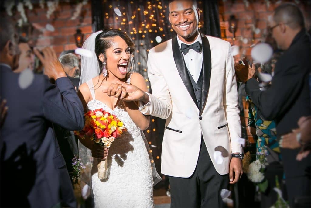 bride and groom smiling and excited as they walk out from their ceremony, Gallery J, Orlando, FL