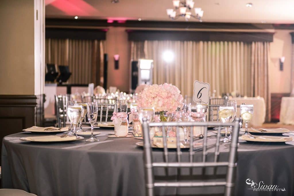 reception set up, silver tablecloth, silver back chairs, pink floral centerpieces, Orlando, FL