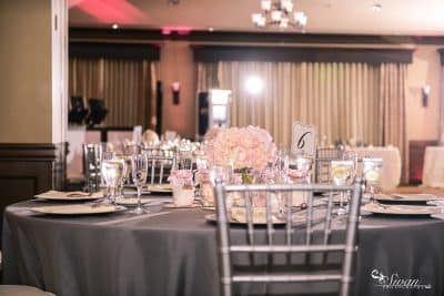 reception set up, silver tablecloth, silver back chairs, pink floral centerpieces, Orlando, FL