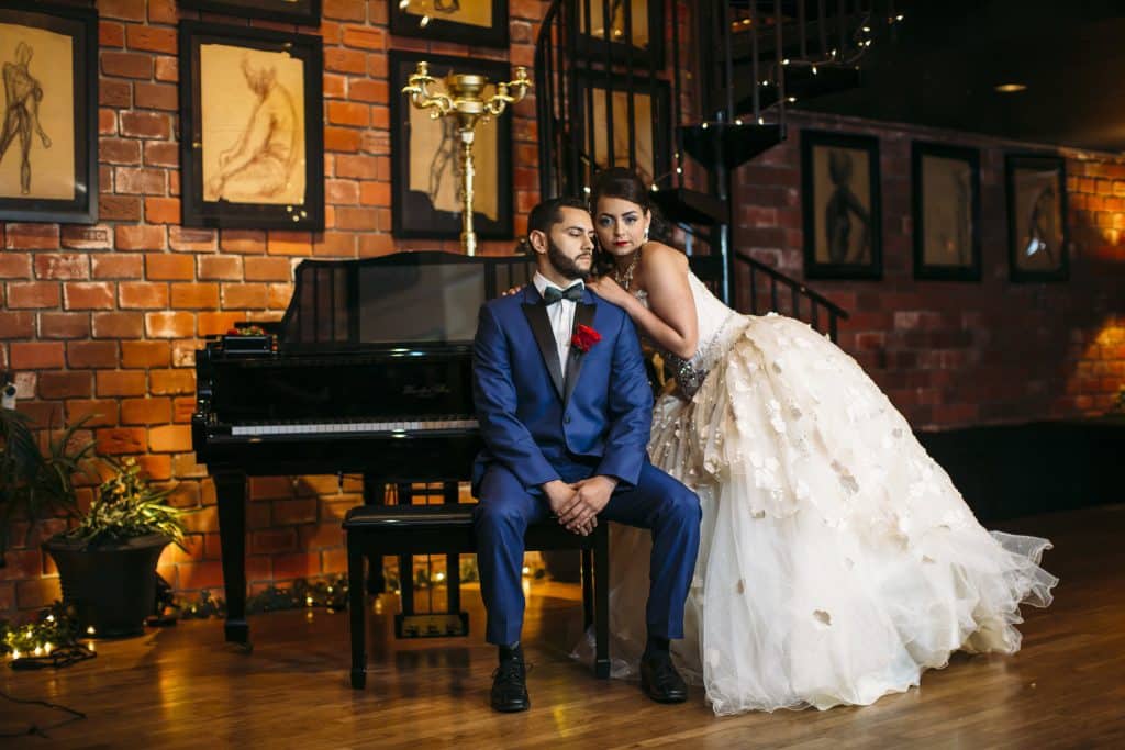 bride and groom sitting on the piano bench, Gallery J, Orlando, FL