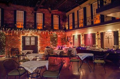 outdoor patio area, red uplighting, table and chairs with white tablecloths, courtyard area of the building, Gallery J, Orlando, FL