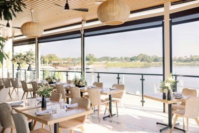indoor set up of tables with a Lakeview, large open windows, ceiling fans, Orlando, FL
