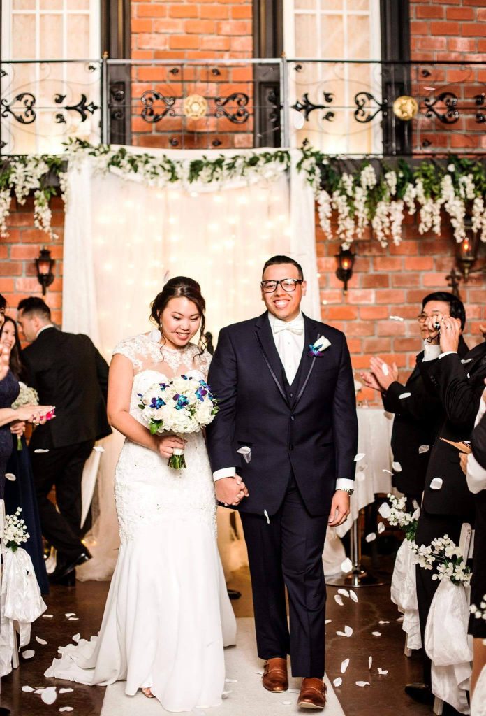 bride and groom after their wedding ceremony, hand in hand, facing their friends and family, Gallery J, Orlando, FL