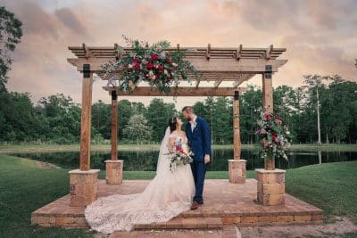 bride and groom standing under the pergola, looking into each other's eyes, Daylin Lavoy Photography, Orlando, FL