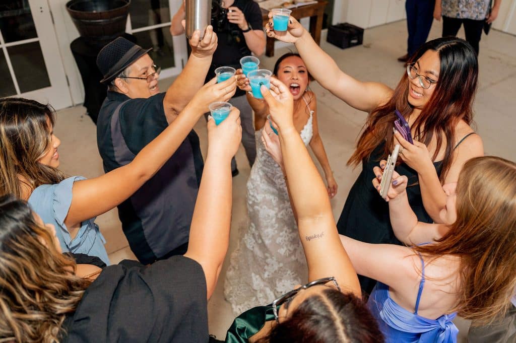 bride and friends toasting their wedding with blue drinks from beck n call bartenders