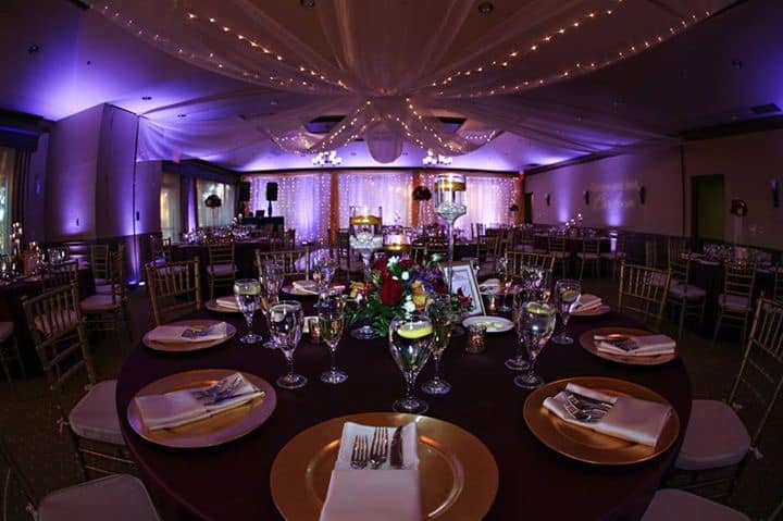 round tables, black tablecloths, gold chargers, white napkins, purple uplighting, Falcon's Fire Golf Club, Orlando, FL