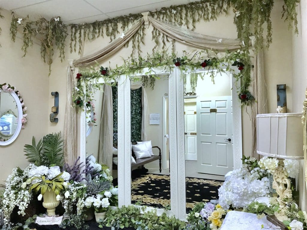 indoor area of Gallery J, moss and greenery hanging from the ceiling, white curtains, white doors, white flowers, Orlando, FL