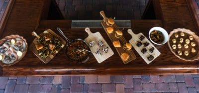 various catering boards with appetizers displayed, tile floor, wooden table, Spregergarten, Orlando, FL