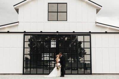 bride and groom standing outside the front of the venue at Scars Farm, Orlando, FL