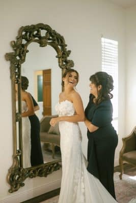 bride getting her dress adjusted in the back, standing in front of the full length mirror in the bridal suite, Sterling Event Venue, Orlando, FL