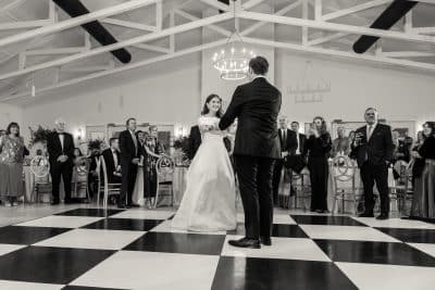 black and white photo, black and white dance floor, bride and groom dancing, guests watching on, Orlando, FL