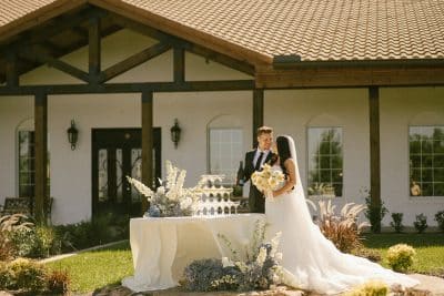bride and groom standing by the champagne table, glasses stacked and filled with champagne, Orlando, FL