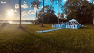 zoomed out photo of lawn with an aisle, rows of chairs, ceremony set up, Ventura Country Club, Orlando, FL