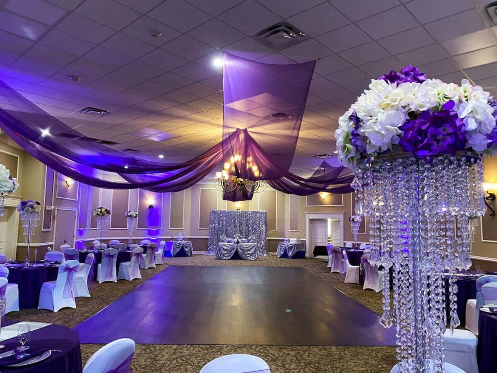 dance floor, purple uplighting, tall centerpieces with white and purple flowers, Orlando, FL