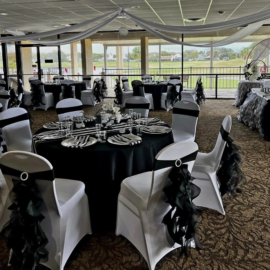 sunroom area, round tables, black tablecloths, white chair backs, black bows, Orlando, FL