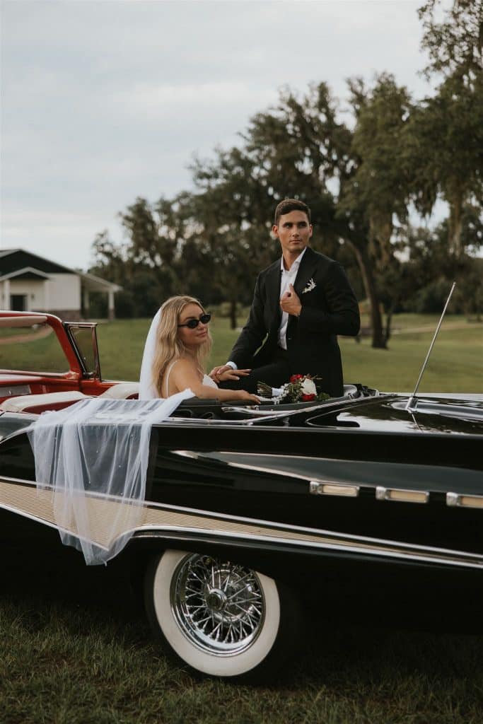 bride and groom cruising in a vintage car after their wedding, Orlando, FL