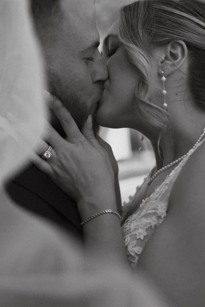 black and white photo, close up with a bride and groom kissing, Orlando, FL