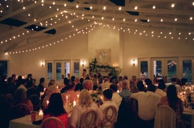 indoor reception set up, lights strung above the tables, candlelight on the tables, Orlando, FL