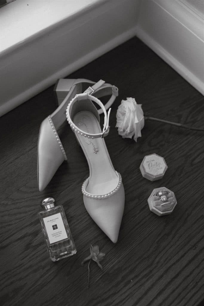 wedding flatlay, wedding shoes, perfume, jewelry, white rose, rings, Orlando, FL