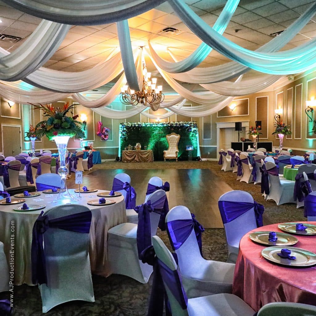 colorful reception set up with green uplighting, pink and green tablecloths with purple chair backs, dance floor, Ventura Country Club, Orlando, FL