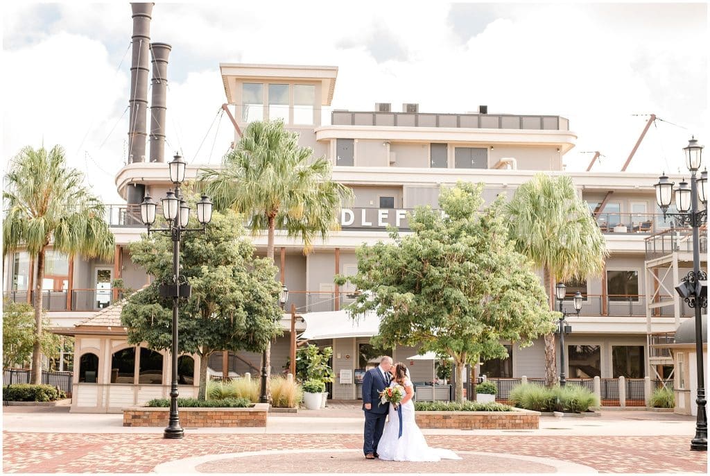 Disney Springs courtyard outside the Paddlefish boat, wedding couple standing together, Orlando, FL