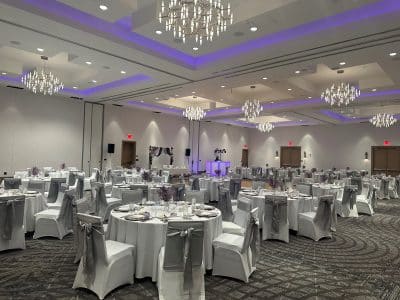 purple uplighting, grey bows on the chair covers, round tables, The Celeste Hotel, Orlando, FL