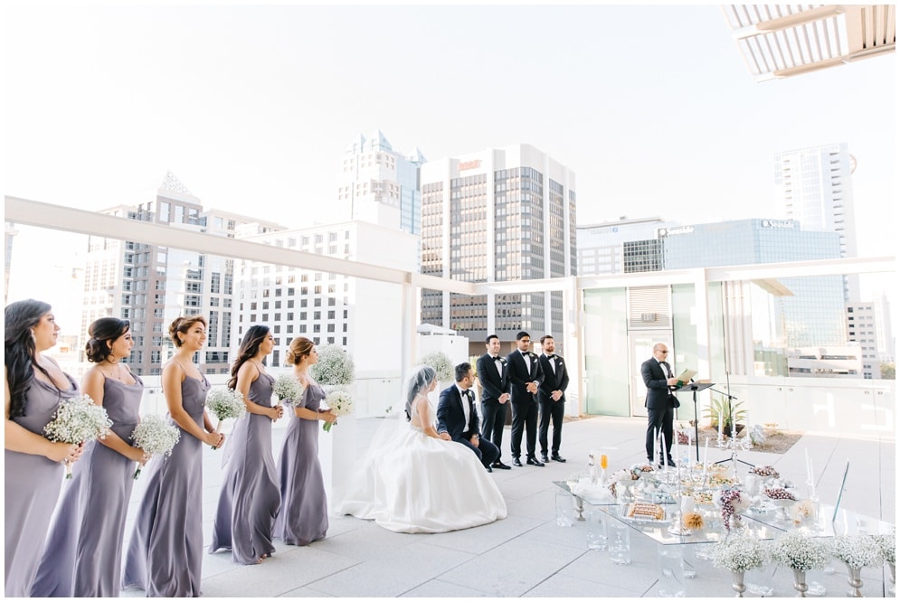 rooftop wedding ceremony, wedding party on either side of the wedding couple, officiant, Orlando, FL