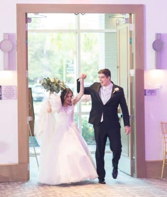 bride and groom entering their reception, holding hands, The Celeste Hotel, Orlando, FL