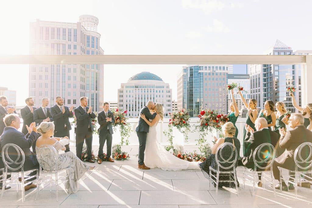 bride and groom kissing after their ceremony, rooftop, daytime, Orlando, FL