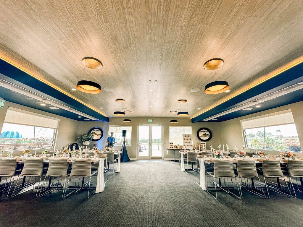 long tables set in the dining room, white tablecloths, large windows, wooden ceilings, Orlando, FL